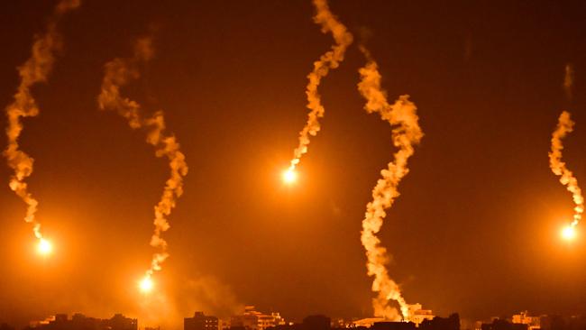 Flares are dropped by Israeli forces above the Gaza Strip amid ongoing battles between the IDF and Hamas last Sunday. Picture: AFP