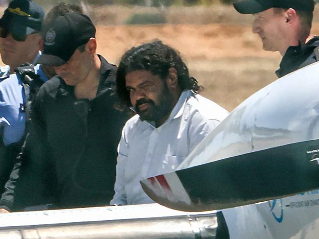 Terence Darrell Kelly is being taken to prison in Perth by SOG for alleged kidnapping of Cleo Smith, Carnarvon Airport.Pic Colin Murty