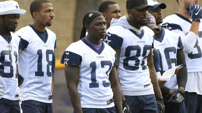 Axed Dallas Cowboys wide receiver Lucky Whitehead (13) stands with fellow receivers during practice before he was cut by the team.