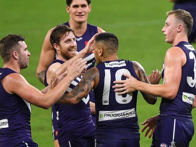 PERTH, AUSTRALIA - APRIL 24: Reece Conca and Michael Walters of the Dockers celebrates a goal during the 2021 AFL Round 06 match between the Fremantle Dockers and the North Melbourne Kangaroos at Optus Stadium on April 24, 2021 in Perth, Australia. (Photo by Daniel Carson/AFL Photos via Getty Images)