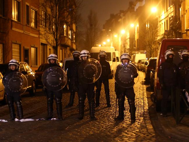 Police officers guard a road after raids in which several people, including Paris attacks suspect Salah Abdeslam, were arrested. Picture: Getty