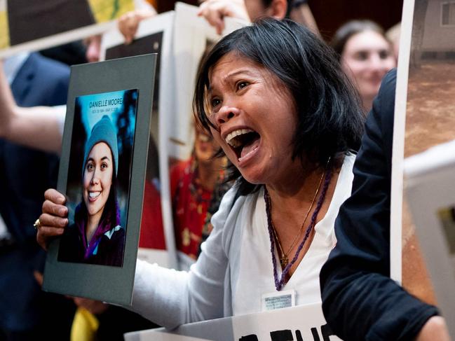 WASHINGTON, DC - JUNE 18: Clariss Moore of Toronto, Canada, holds a photograph of her daughter Danielle Moore and stands with other family members of those killed in the Ethiopian Airlines Flight 302 and Lion Air Flight 610 as she becomes emotional while screaming at Boeing CEO Dave Calhoun as he departs following a Senate Homeland Security and Governmental Affairs Investigations Subcommittee hearing on Boeing's broken safety culture on Capitol Hill on June 18, 2024 in Washington, DC. Calhoun said he is "here to take responsibility" as he testified before the Senate to discuss ongoing quality and safety issues after a new 737 Max 9 airplane's door panel blew out mid-flight during an Alaska Airlines flight in January.   Andrew Harnik/Getty Images/AFP (Photo by Andrew Harnik / GETTY IMAGES NORTH AMERICA / Getty Images via AFP)
