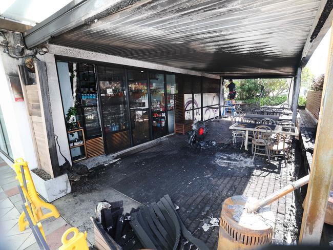 Workmen start assesing the damage from a fire overnight at a cafe on the front of the Pacific Private Hospital on Nerang Street Southport . Picture Glenn Hampson