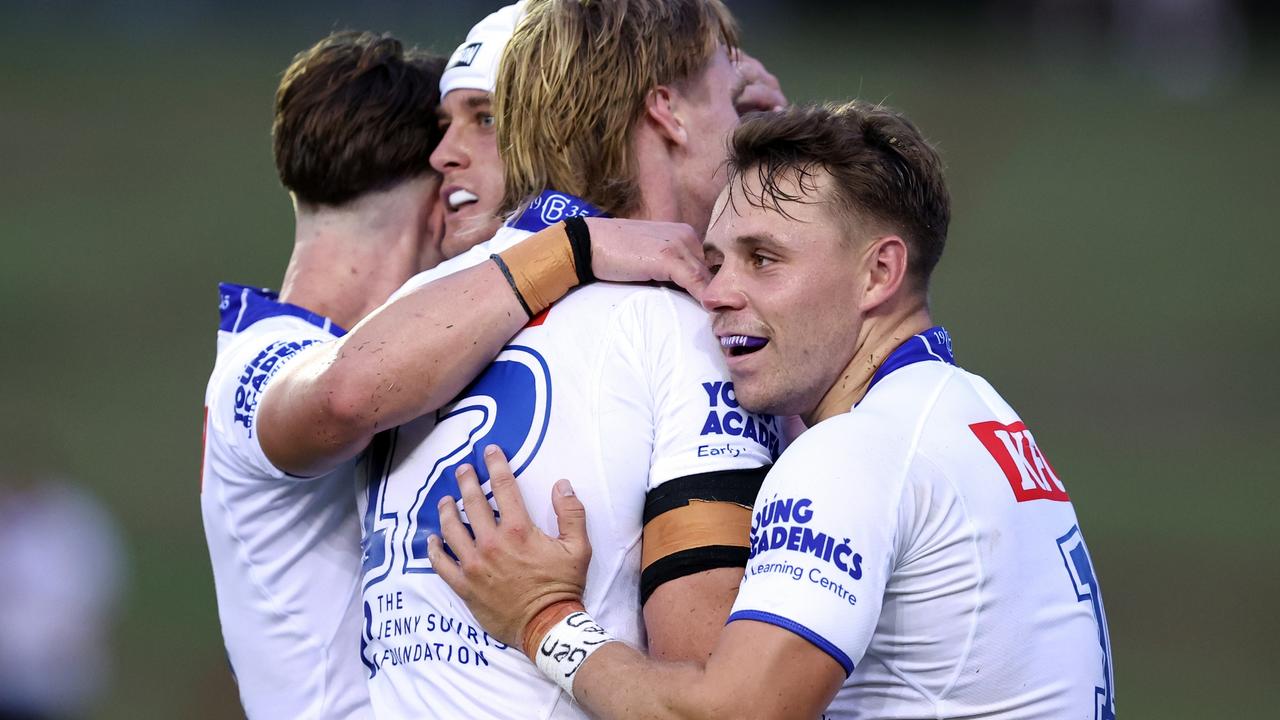 Blake Wilson celebrates a try with Jacob Preston and Blake Taafe. Picture: Brendon Thorne/Getty Images