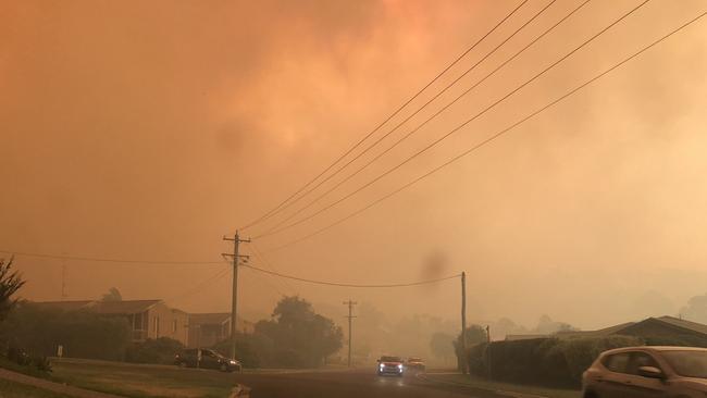 Smoke from fires engulf the village of Tathra on the south coast of NSW.