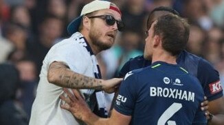 Police would like to speak with this man, seen talking to Victory player Leigh Broxham, over the AAMI Park chaos at Saturday night’s Melbourne Derby. Picture: Supplied by Victoria Police