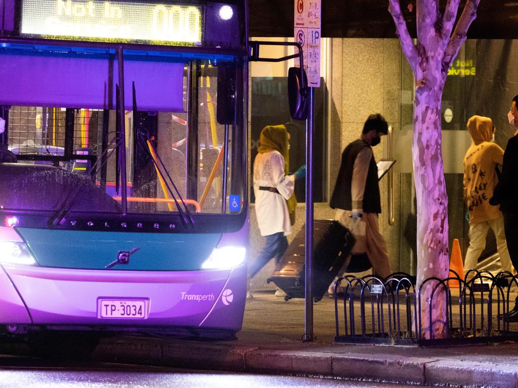 Evacuees from Afghanistan enter the Hyatt Hotel on August 20, 2021 in Perth, Australia. The people on the flight from the United Arab Emirates are the first evacuees to arrive in Australia following the federal government's Afghanistan evacuation mission. Picture: Matt Jelonek/Getty Images