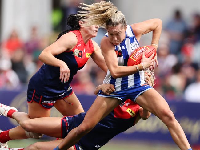 MELBOURNE , AUSTRALIA. November 12, 2023.  AFLW. Qualifying final. Melbourne vs North Melbourne at Ikon Park, Carlton.    Alice OÃLoughlin of the Kangaroos  gets tackled by Melbournes Eliza McNamara         . Pic: Michael Klein