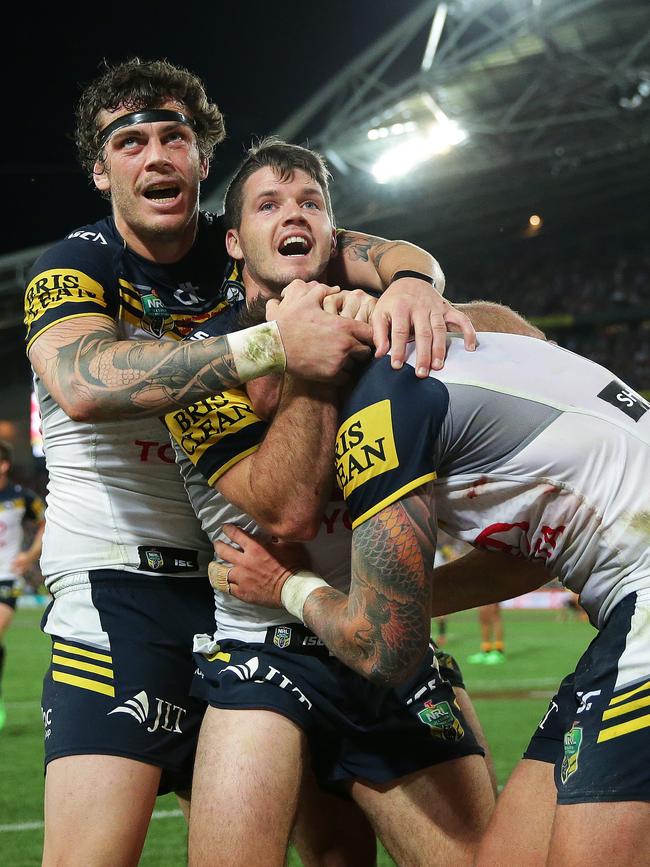 And is embraced by Ethan Lowe and Lachlan Coote. Pictures: Phil Hillyard