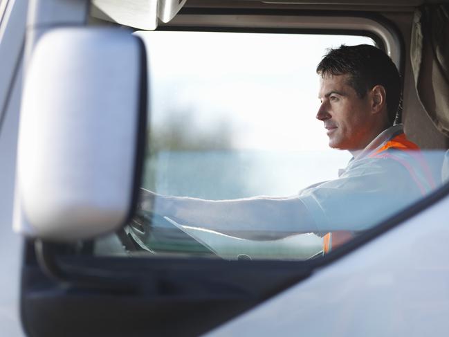 CAL00373_Big_Rigs_Image_1_GettyImagescaucasian; color image; commerce; day; driver; driving; england; freight transportation; head and shoulders; horizontal; industry; man; mid adult; occupation; on the move; one mid adult man only; one person; outdoors; people; photography; reflector-vest; reliability; safety; semi-truck; shipping; side view; sitting; transportation; truck; window; worker; working; yorkshire; 35-39 years