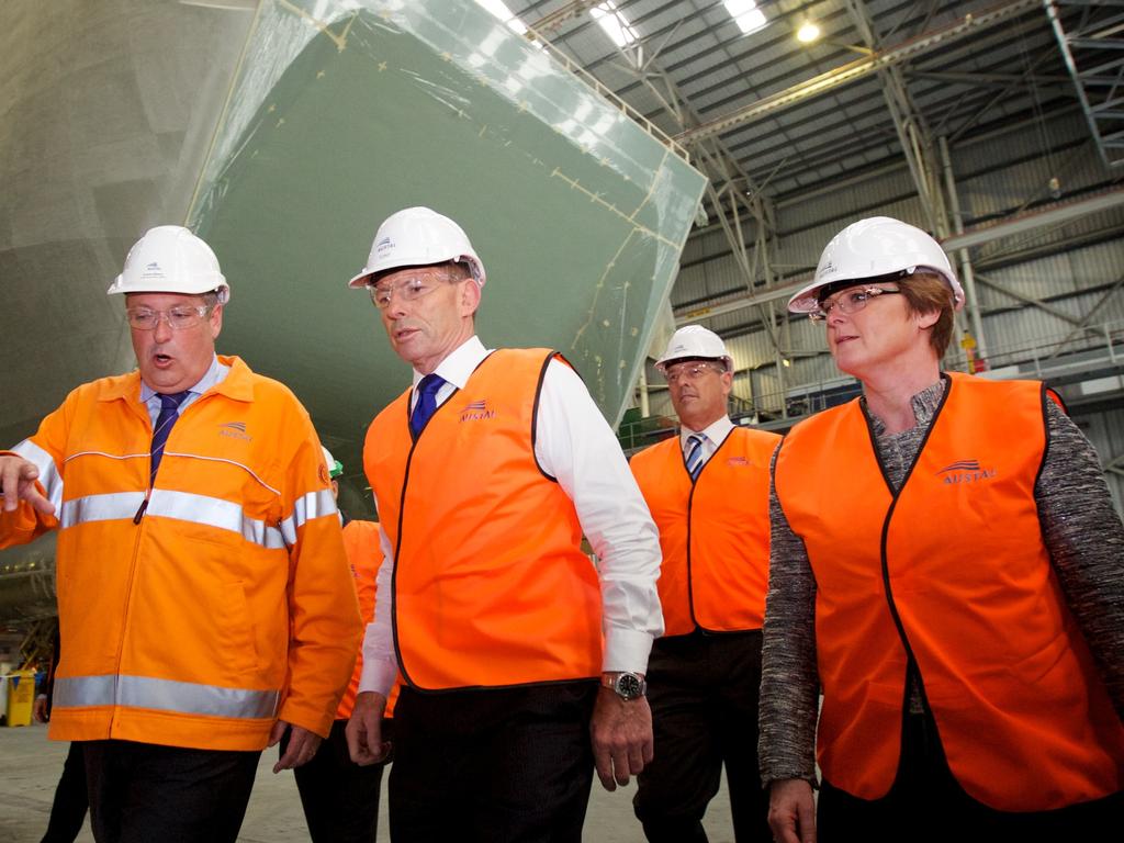 Reynolds with former Prime Minister Tony Abbott on a tour of a Royal Navy of Oman Hi-Speed support vessel in August 2015. Picture: Richard Wainwright