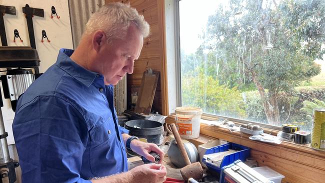 Premier Jeremy Rockliff changing a drill bit in his workshop. Picture: Simon McGuire.