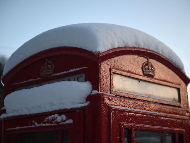 An iconic red telephone box is covered with snow as temperatures plummet, in the village of Little Hayfield in the Peak district of northern England on February 28, 2018. Picture: AFP
