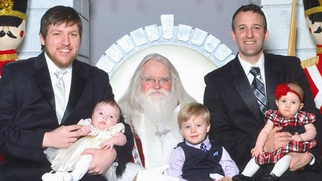 Thirty four years on Santa's lap ... Martin and Mike Gray are still taking photos as part of their family tradition. Picture:...