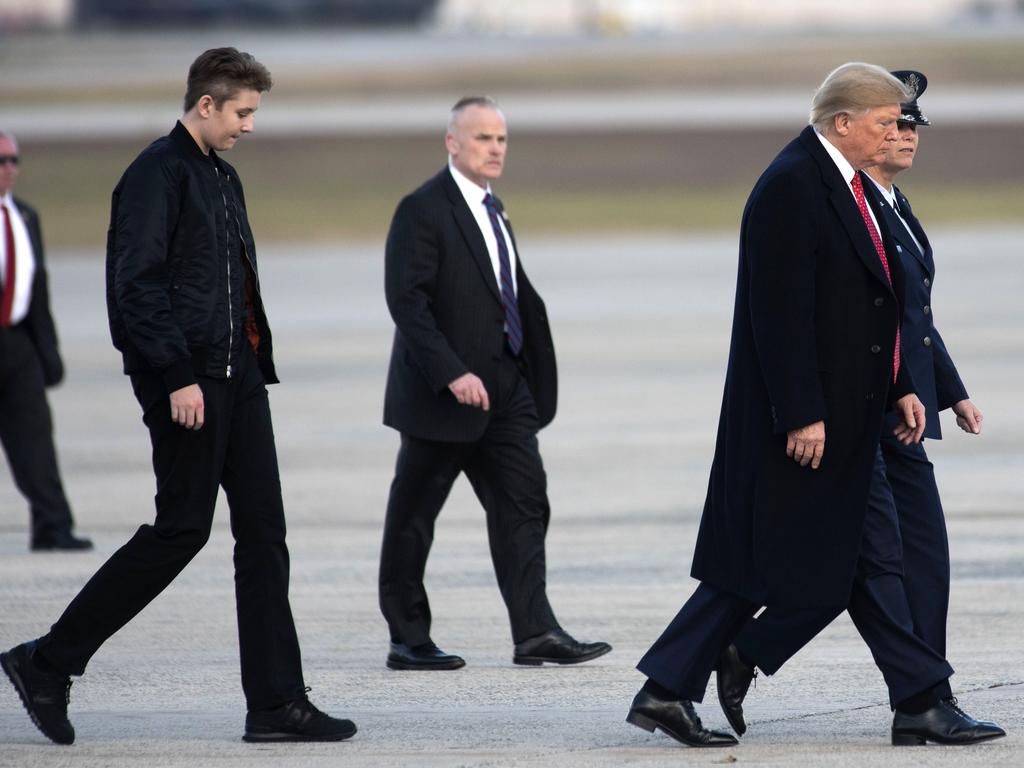 Barron Trump, 13, towers over his parents Donald and Melania The