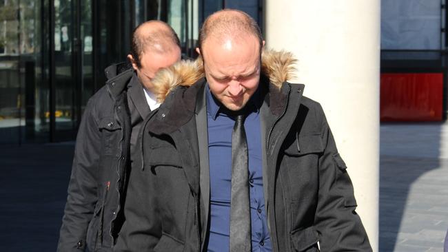 Australian Federal Police officer Joshua Rod Tiffen (front) and his twin brother Kenan Lee Tiffen leave court on an earlier date.