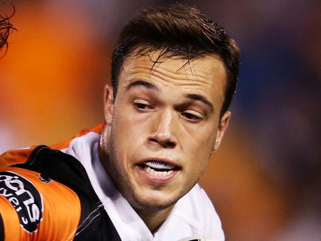 SYDNEY, AUSTRALIA - APRIL 17: Luke Brooks of the Tigers takes on the defence during the round seven NRL match between the Wests Tigers and the Melbourne Storm at Leichhardt Oval on April 17, 2016 in Sydney, Australia. (Photo by Matt King/Getty Images)