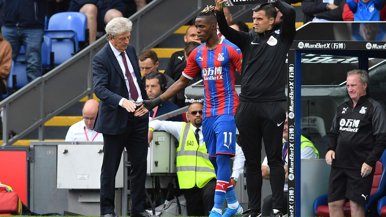 He’s back: Crystal Palace's Ivorian striker Wilfried Zaha (C) ended his stoush with the club and played in their English Premier League opener. (Photo by Ben STANSALL / AFP)