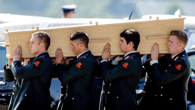 Dutch military men carry a coffin containing the remains of a victim of downed flight MH17. Picture: Robin van Lonkhuijsen