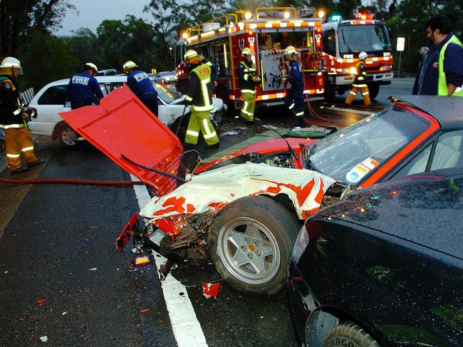 A woman was trapped in the white car after a smash on Mona Vale Rd, Ingleside, near the intersection with Addison Rd, in 2006. Picture: John Grainger