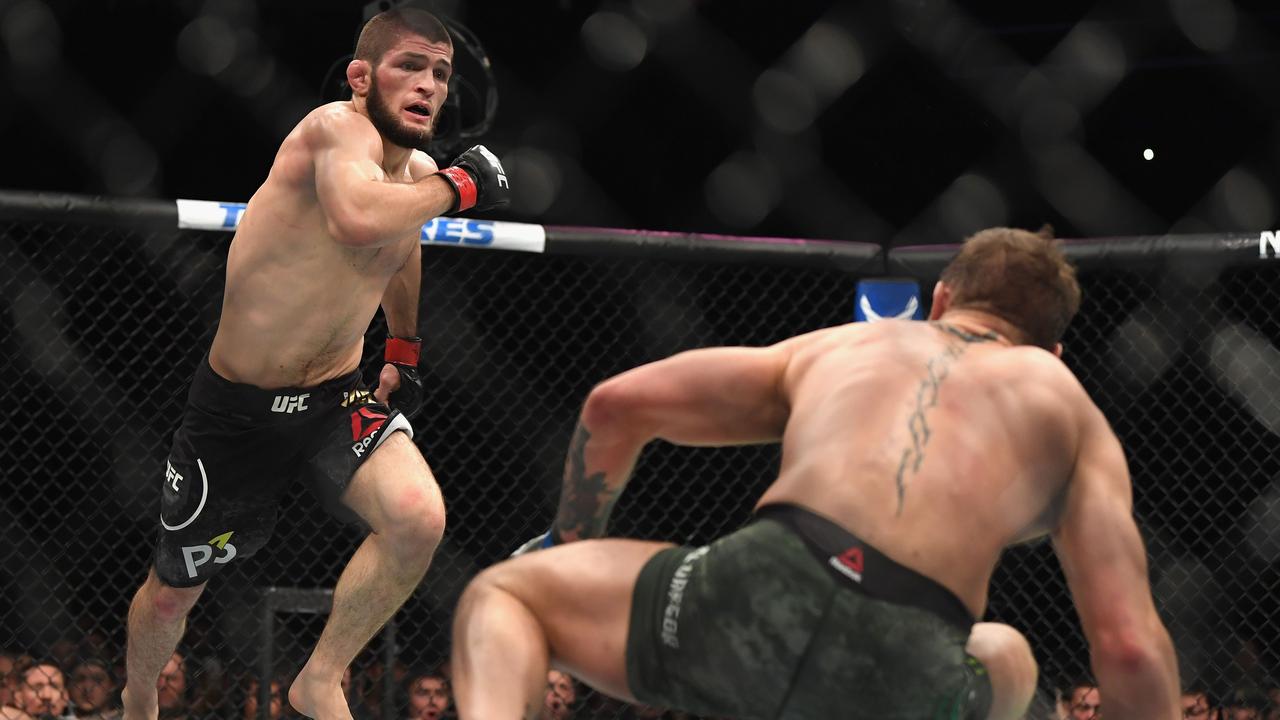 Khabib Nurmagomedov pursues Conor McGregor after knocking him down in round two (Photo by Harry How)