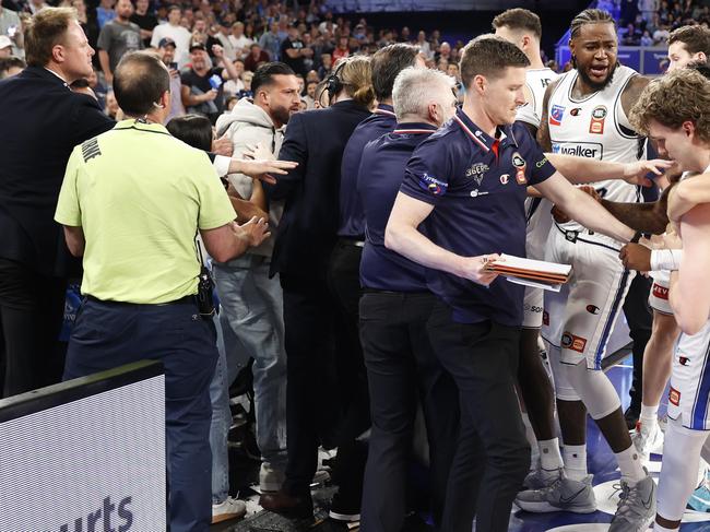 MELBOURNE, AUSTRALIA - NOVEMBER 17: A fight breaks out on the Adelaide 36ers interchange as member of the crowd gets involved with the players on the bench during the round nine NBL match between Melbourne United and Adelaide 36ers at John Cain Arena, on November 17, 2024, in Melbourne, Australia. (Photo by Darrian Traynor/Getty Images)