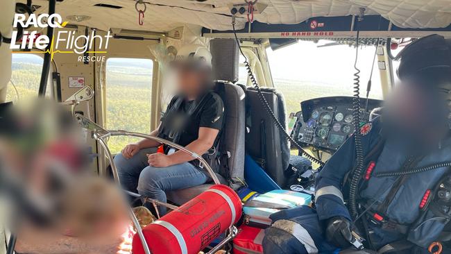 A young girl, a couple and their four dogs were winched to safety after their home was cut off by extensive flooding in the area. Photo: RACQ LifeFlight