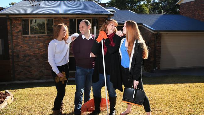 John Yeaman and his wife Annmaree and daughters Emily and Molly pictured putting the finishing touches on their Carlingford home which is on the market. Picture: Toby Zerna