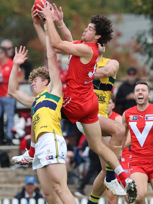 Rooster Karl Finlay flies high over the pack to take a screamer against Woodville-West Torrens. Picture: SANFL/David Mariuz.