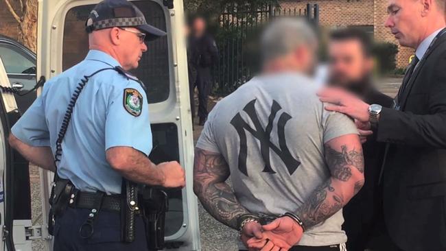 NSW Police arrest a second man during the Finks bikie clubhouse raid on Thursday. Picture: Strike Force Rednap