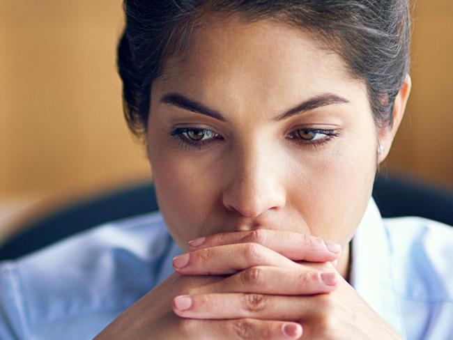 Shot of a young businesswoman looking stressed while working on her lapto