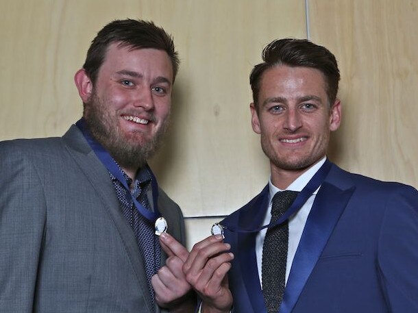 Ryan Mullett (right) of Vermont shows off the Chandler Medal he won in 2014.