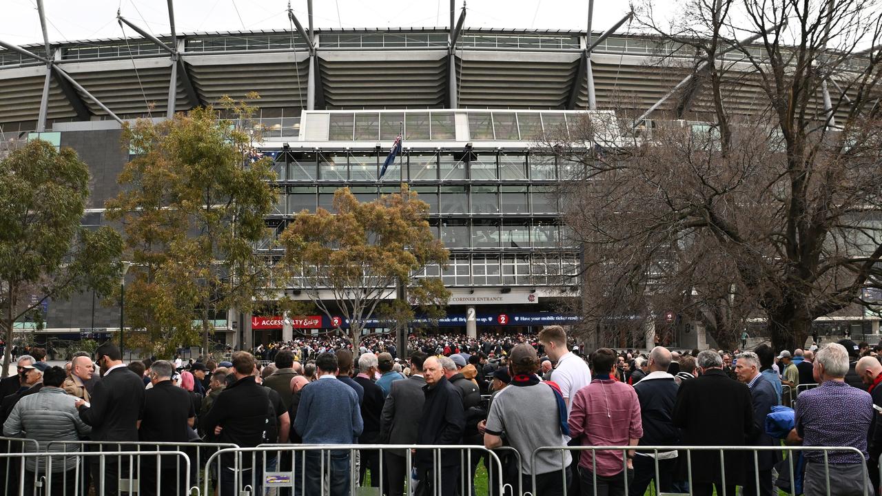 Fans queue to enter the MCG. Picture: Quinn Rooney