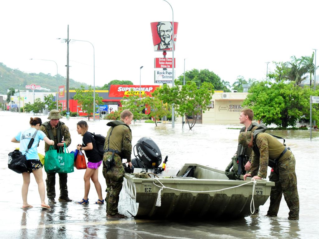 Soldiers help evacuate people in Charters Towers Rd, Hermit Park. Picture: Evan Morgan