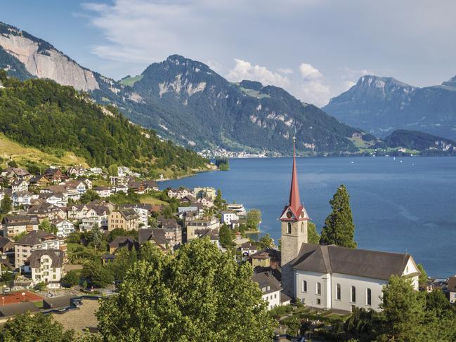 DECEMBER 6 2015 DEALS Lake Lucerne in Switzerland. For use with Insight Vacations copy. Picture: Supplied Beautiful mountain scenery with the town of Weggis at the northern shore of Lake Lucerne in beautiful evening light at sunset, Canton of Lucerne, central Switzerland