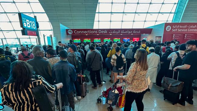 Passengers queue at a flight connection desk at the Dubai International Airport. Picture: AFP