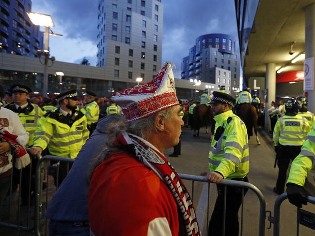 Police guard the stadium entrances as the kick off is delayed