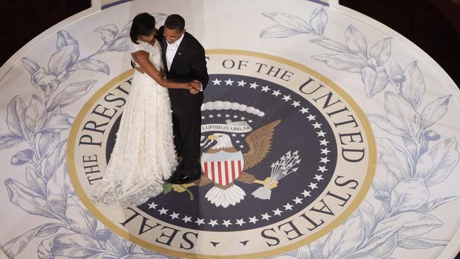 Obama and first lady Michelle Obama dance at the Commander in Chief Inaugural Ball at the National Building Museum in Washington in 2009. Americans remain deeply divided over his legacy. Picture: Charles Dharapak/AP