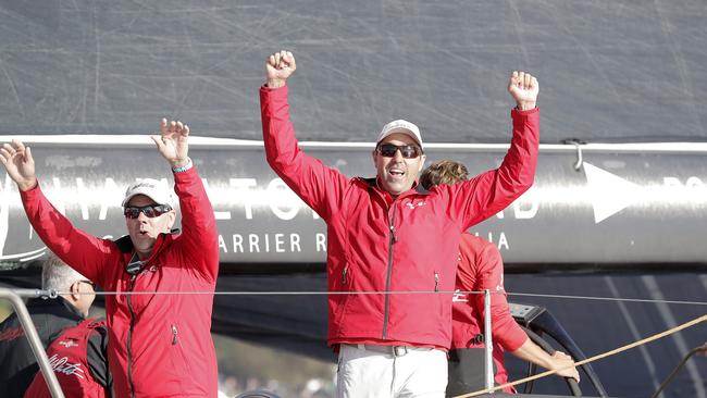 Wild Oats XI skipper Mark Richards celebrates as he crosses the finish line last year.