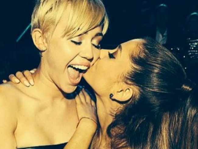 Pop princesses...Ariana Grande’s post of her planting a kiss on Miley Cyrus was the third most popular photo of 2014. Picture: Instagram/Ariana Grande