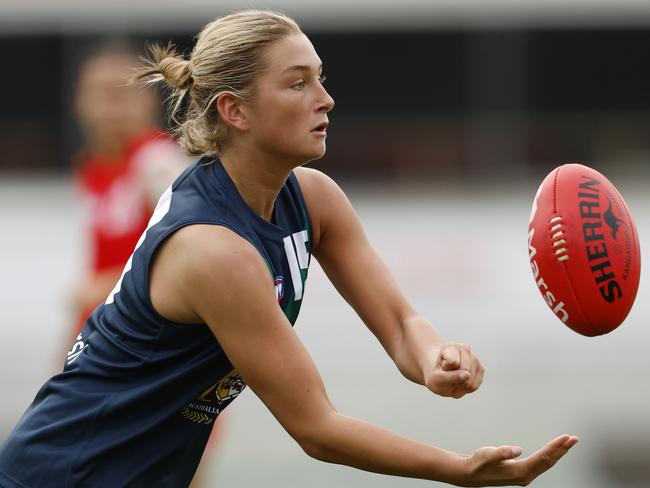 MELBOURNE, AUSTRALIA - APRIL 06:  Ash Centra of the AFL National Academy Girls handballs during the Marsh AFL National Academy Girls vs U23 All-Stars at Ikon Park on April 06, 2024 in Melbourne, Australia. (Photo by Darrian Traynor/AFL Photos/via Getty Images)