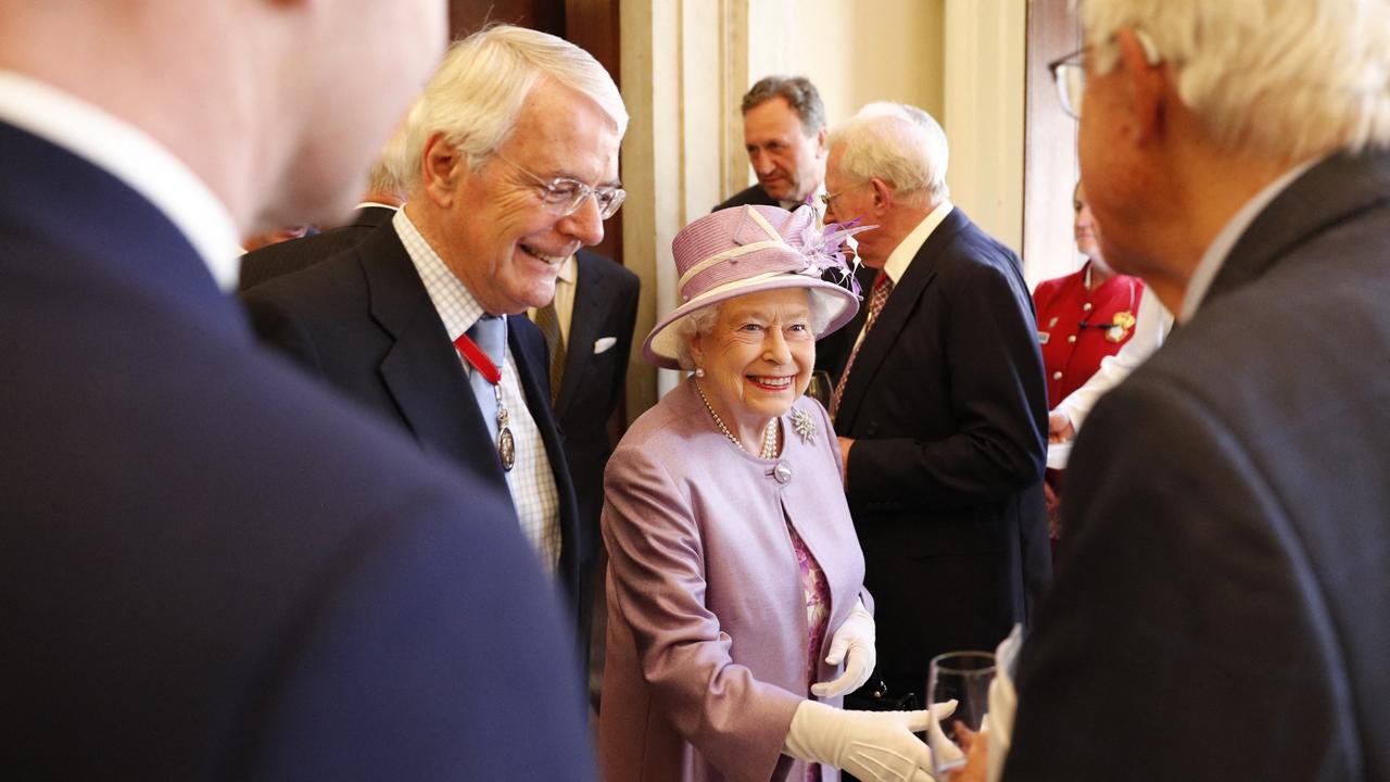 Queen Elizabeth II greets guests including former prime minister John Major at a reception after an Evensong service in celebration of the centenary of the Order of the Companions of Honour at Hampton Court Palace, (Photo by Adrian DENNIS / File Photo)