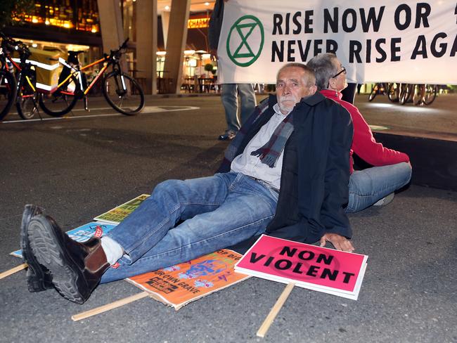 Adani protesters blocked an intersection in the cultural precinct of Brisbane last night. Picture: Richard Gosling/AAP