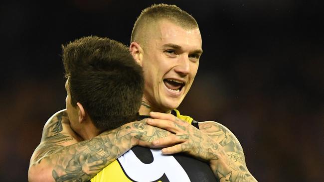 Dustin Martin hugs Trent Cotchin after the captain kicked a goal. Picture: AAP