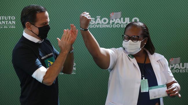 Nurse Monica Calazans celebrates next to Governor of Sao Paulo Joao Doria (L) after receiving the first CoronaVac vaccination shot in Brazil. Picture: Getty