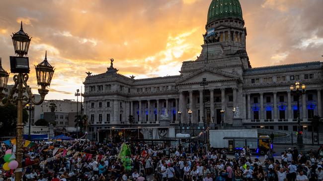 Volunteers and homeless people take part in a Christmas solidarity dinner called 'No Families Without Christmas' in front of the National Congress in Buenos Aires on December 24. Picture: AFP