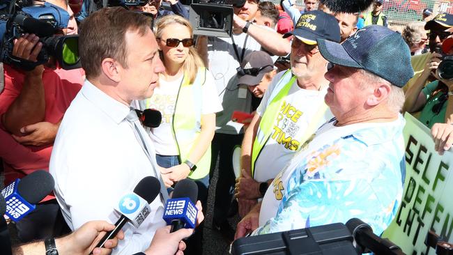 Premier Steven Miles speaks to crime victim Russel Field outside parliament. Picture: Tertius Pickard