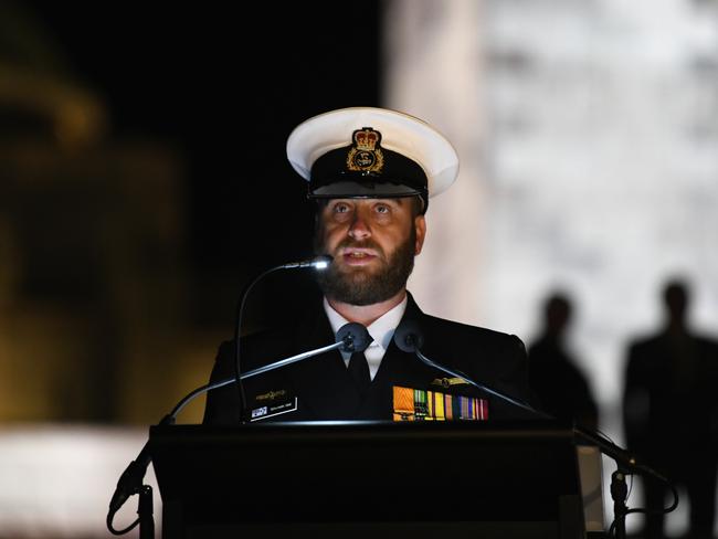 Benjamin Sime reads letters and diaries of Australians who experienced war first-hand during the dawn service at the National War Memorial in Canberra. Picture: AAP