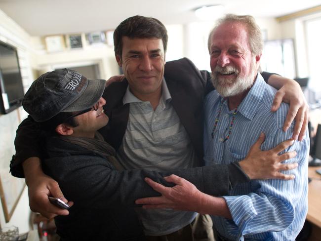 (FILES) In this file photo taken on April 17, 2012 Agence France-Presse (AFP) photographer Shah Marai (C) embraces colleagues Massoud Hossaini (L) and Lawrence Bartlett (R), after Hossain had won the Pulitzer Prize, at the AFP office in Kabul. Agence France-Presse's chief photographer in Kabul, Shah Marai, was killed April 30, AFP has confirmed, in a secondary explosion targeting a group of journalists who had rushed to the scene of a suicide blast in the Afghan capital. / AFP PHOTO / JOHANNES EISELE