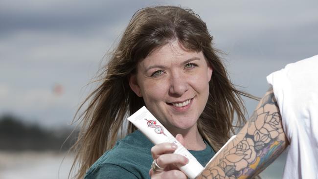 Danielle Chisholm trying the The Original Sin sunscreen, a sunscreen designed for people with tattoos. Photo: Jerad Williams